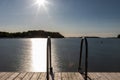 A swimming jetty during a golden sunset over the Turku Archipelago near the village of Naantali Royalty Free Stock Photo