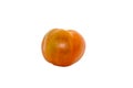 A ripe orange tomato with a slightly irregular shape rests on a plain white background. Royalty Free Stock Photo