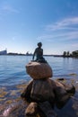 The statue of the little mermaid by the waterside at the Langelinie promenade in Copenhagen Royalty Free Stock Photo