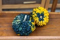 Two uniquely textured gourds sit on a wooden surface. Royalty Free Stock Photo