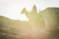 Imilchil, Morocco - October 05, 2013. Berber woman with child riding the horse in sunset