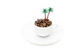 Imitation of an exotic island with palm trees in a coffee cup