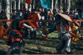 Two representatives of historical clubs in armor fight with swords. Royalty Free Stock Photo