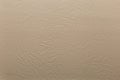 Beige faux leather with crumpled embossing. Texture for background and design.