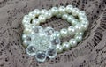 Imitation pearl hair band closeup on lace. Royalty Free Stock Photo
