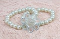 Imitation pearl hair band closeup on lace. Royalty Free Stock Photo