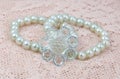 Imitation pearl hair band closeup on sweet lace. Royalty Free Stock Photo