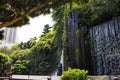 imitation of a waterfall in the park blends with the real nature