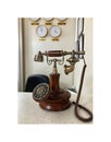 Immaculate vintage wooden and metal telephone on hotel reception desk