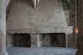 Immense double fireplace made of stone inside a living room
