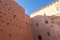 The immense walls of a kasbah of a semi-desert barbarian village in the atlas mountains surrounded by date palms along