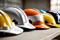 Colorful construction safety helmets aligned on clean desk