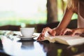 Immersed in a great read. an unidentifiable woman reading a book in a cafe. Royalty Free Stock Photo