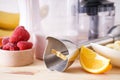 Immersion hand blender with sliced fruit on a wooden background, close up