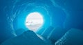 Translucent Blue Ice Cavern in Antarctic Iceberg with Distant Sea and Snow Capped Mountains Under Bright Sky Royalty Free Stock Photo