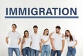 Immigration. Group of young people standing near light wall