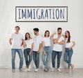 Immigration concept. Group of people standing near light wall