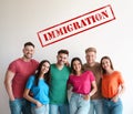 Immigration concept. Group of people standing near light wall Royalty Free Stock Photo