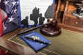 Immigration law concept. Gavel, passport and Silhouette of immigrants on wooden table. Royalty Free Stock Photo