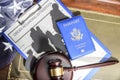 Immigration law concept. Gavel, passport and Silhouette of immigrants on wooden table. Royalty Free Stock Photo