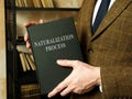 Immigration lawyer holds naturalization process rules book. Royalty Free Stock Photo