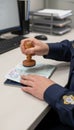 Immigration officer stamping passport for border control clearance Royalty Free Stock Photo