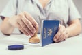 Immigration and passport control at the airport. woman border control officer puts a stamp in the Ukrainian passport. Concept.