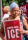Woman Holds Abolish Ice sign at Immigration Rally