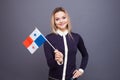 Immigration and the study of foreign languages, concept. A young smiling woman with a Panama flag in her hand