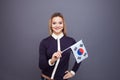 Immigration and the study of foreign languages, concept. A young smiling woman with a Republic of Korea flag