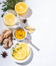 Immune boosting remedy. Flat lay  with ingredients from turmeric, thyme, lemon, star anise and glass water with lemon on white Royalty Free Stock Photo