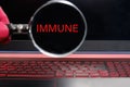 The immune word written on the monitor. the words are visible through a magnifying glass.