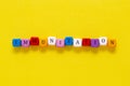 Immunisation word made from colorful cubes over yellow background, top view