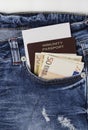 Immunity passport with money in jeans pocket Royalty Free Stock Photo