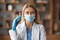 Immunization Concept. Doctor Lady In Medical Mask Holding Syringe With Vaccine Dose Royalty Free Stock Photo