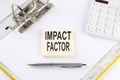 IMPACT FACTOR - business concept, message on the sticker on folder background with calculator Royalty Free Stock Photo