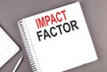 IMPACT FACTOR text on notebook with calculator and pen,business concept Royalty Free Stock Photo