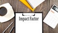 IMPACT FACTOR text on paper with coffee, calculator and notebook. Business concept Royalty Free Stock Photo