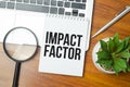 IMPACT FACTOR text on paper with laptop, green plant and pen Royalty Free Stock Photo