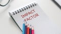 Impact Factor text on white an paper on white background. Royalty Free Stock Photo