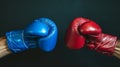 Impact moment between red and blue boxing gloves, dynamic moment. Fist bump. Dark background. Concept of competition Royalty Free Stock Photo