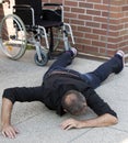 Impaired man on the floor after falling out of wheelchair