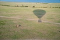 Impala and hot air balloon with shadow over the Masaai Mara Reserve in Kenya Africa