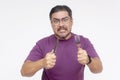 An impatient angry middle aged man holding a fork and knife seething with rage. Demanding to know where his food is at. Isolated Royalty Free Stock Photo