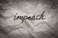 The impeach text word on crumpled paper - government and politics concept