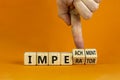 Imperator or impeachment symbol. Businessman hand turns wooden cubes and changes the word `imperator` to `impeachment`. Beauti