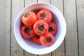 Imperfect persimmons in a bowl