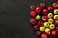 Imperfect red and green apples on a dark background. Bulk. Royalty Free Stock Photo