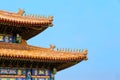 The Imperial Palace in Beijing Forbidden City. curved roofs in traditional Chinese style with figures on the blue sky background