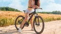 Impersonal portrait of a woman in nature with a bicycle. Recreation and tourism concept